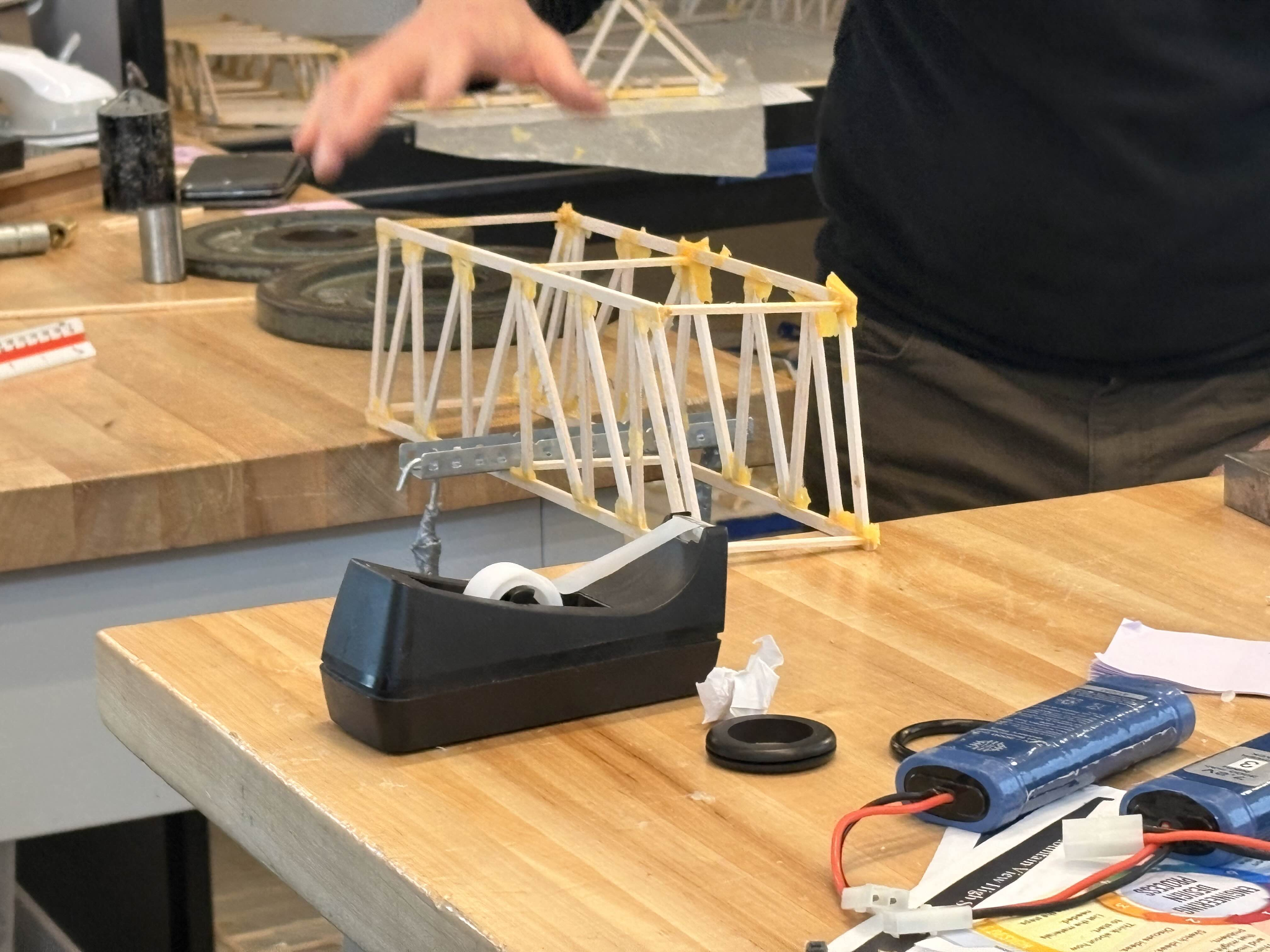 Balsa wood Howe truss bridge during a load test
