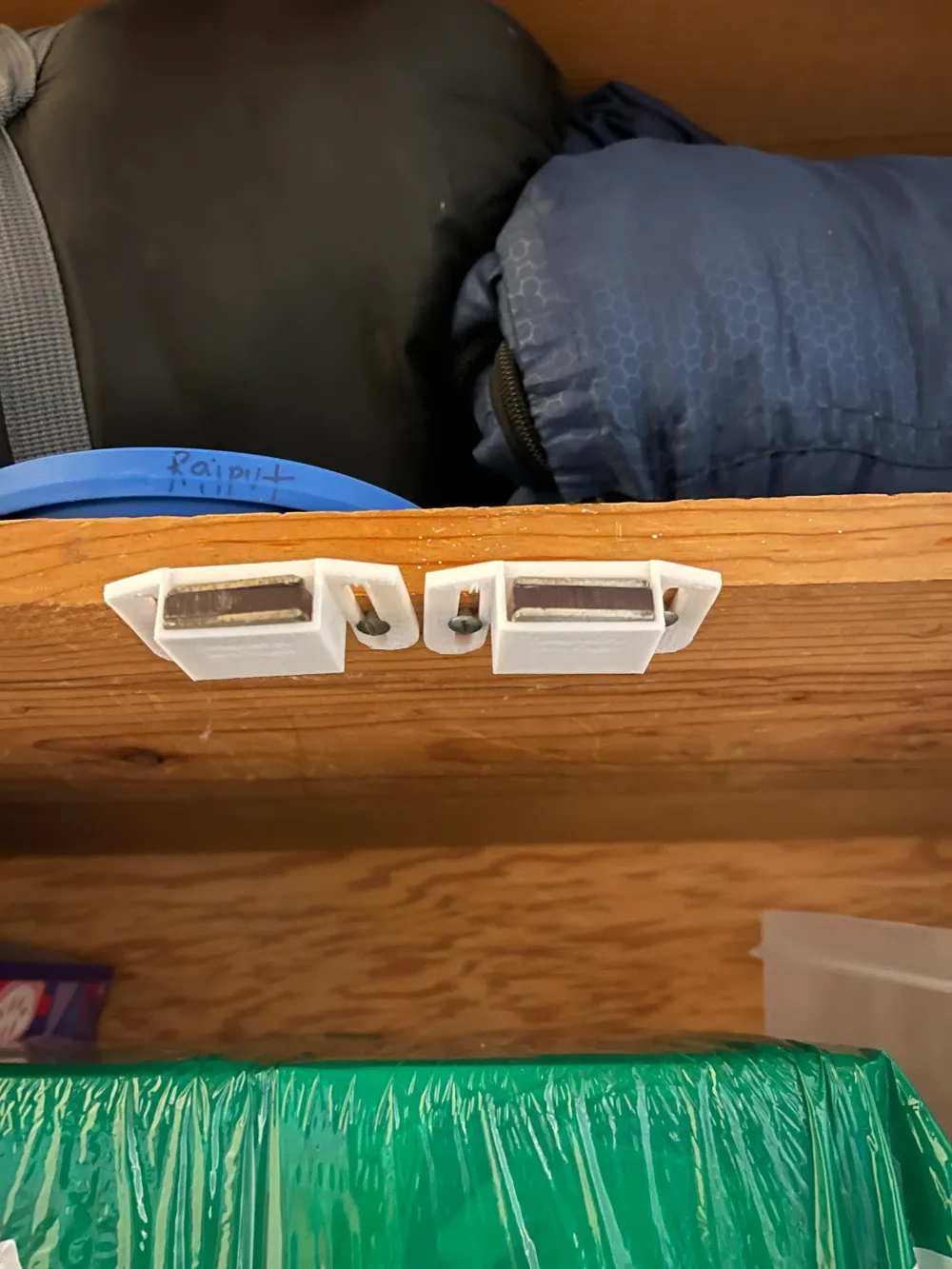 Cabinet magnet holder installed on a wooden cabinet