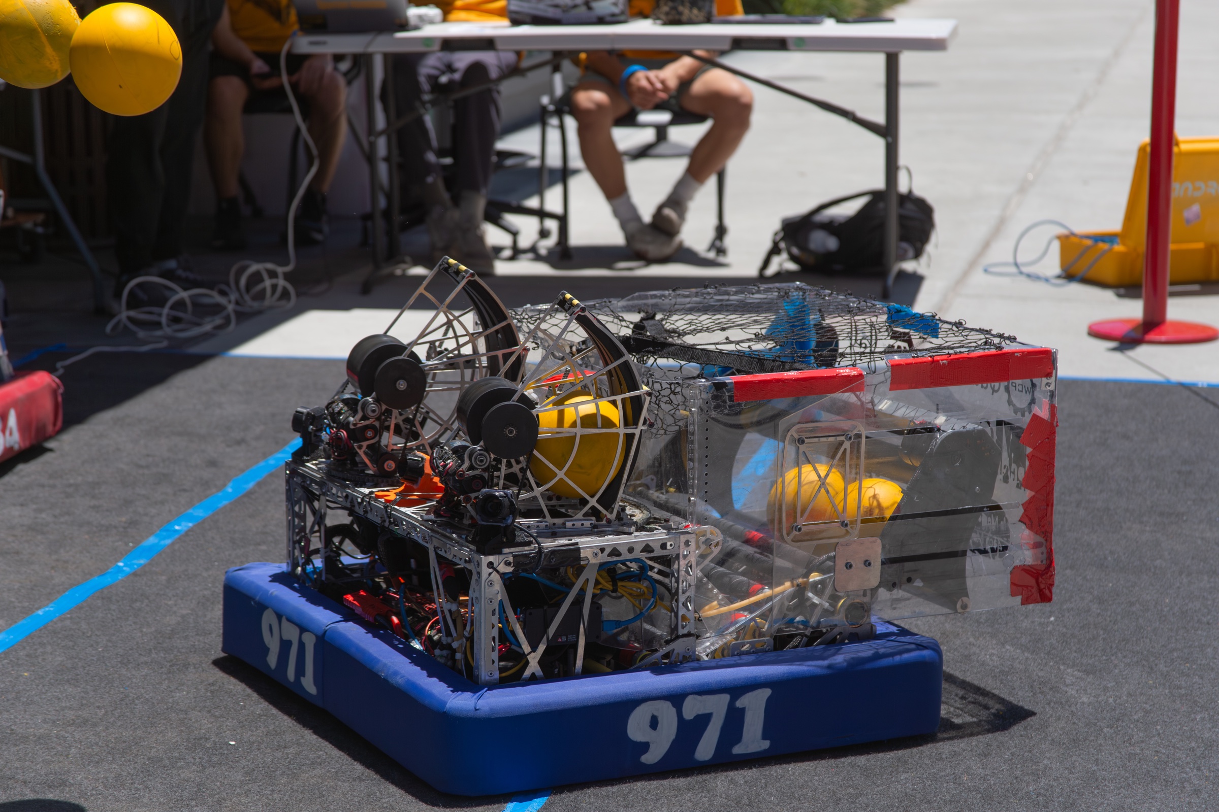 FRC Team 971 robot on the field with yellow game pieces